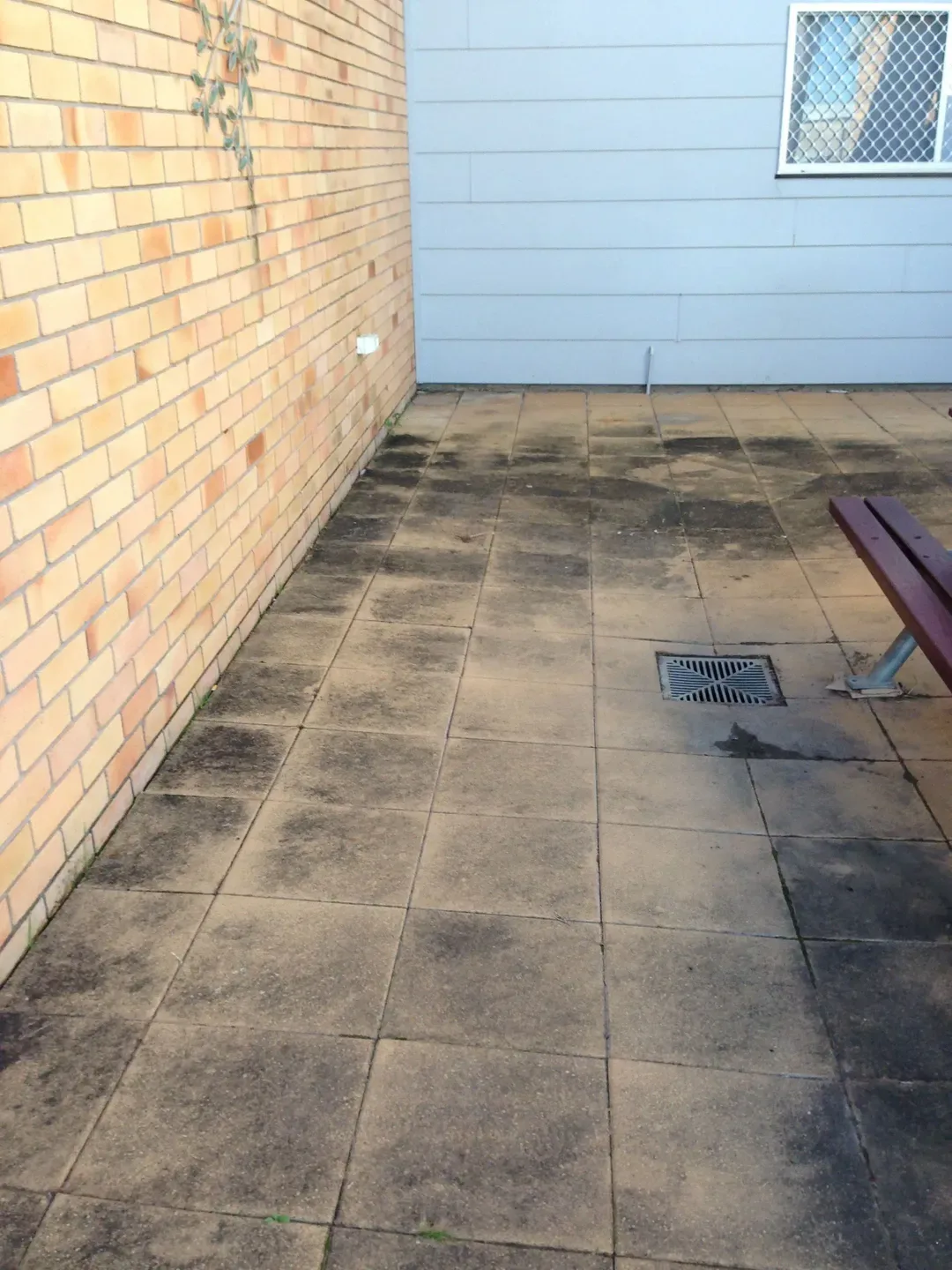 Before — paved courtyard before and after pressure cleaning