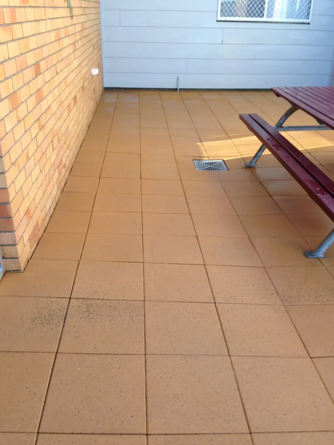 After — paved courtyard before and after pressure cleaning